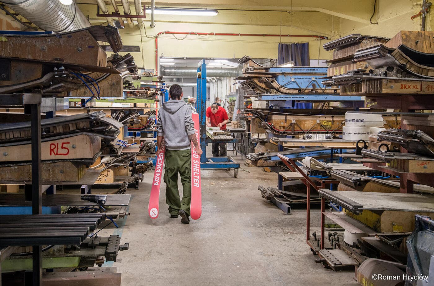 Advanced Shelter test skis carried across the factory floor